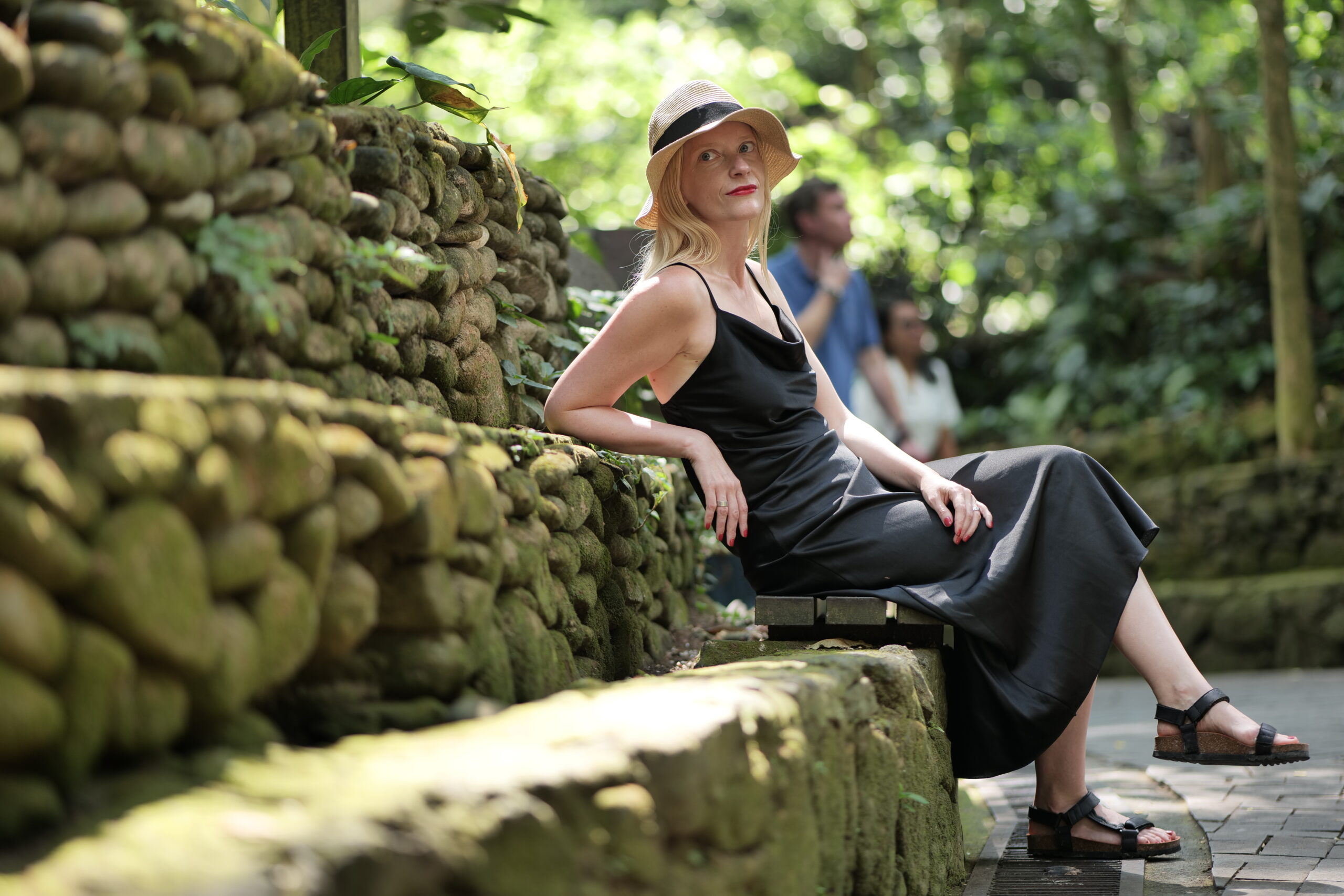 blonde woman sitting in nature