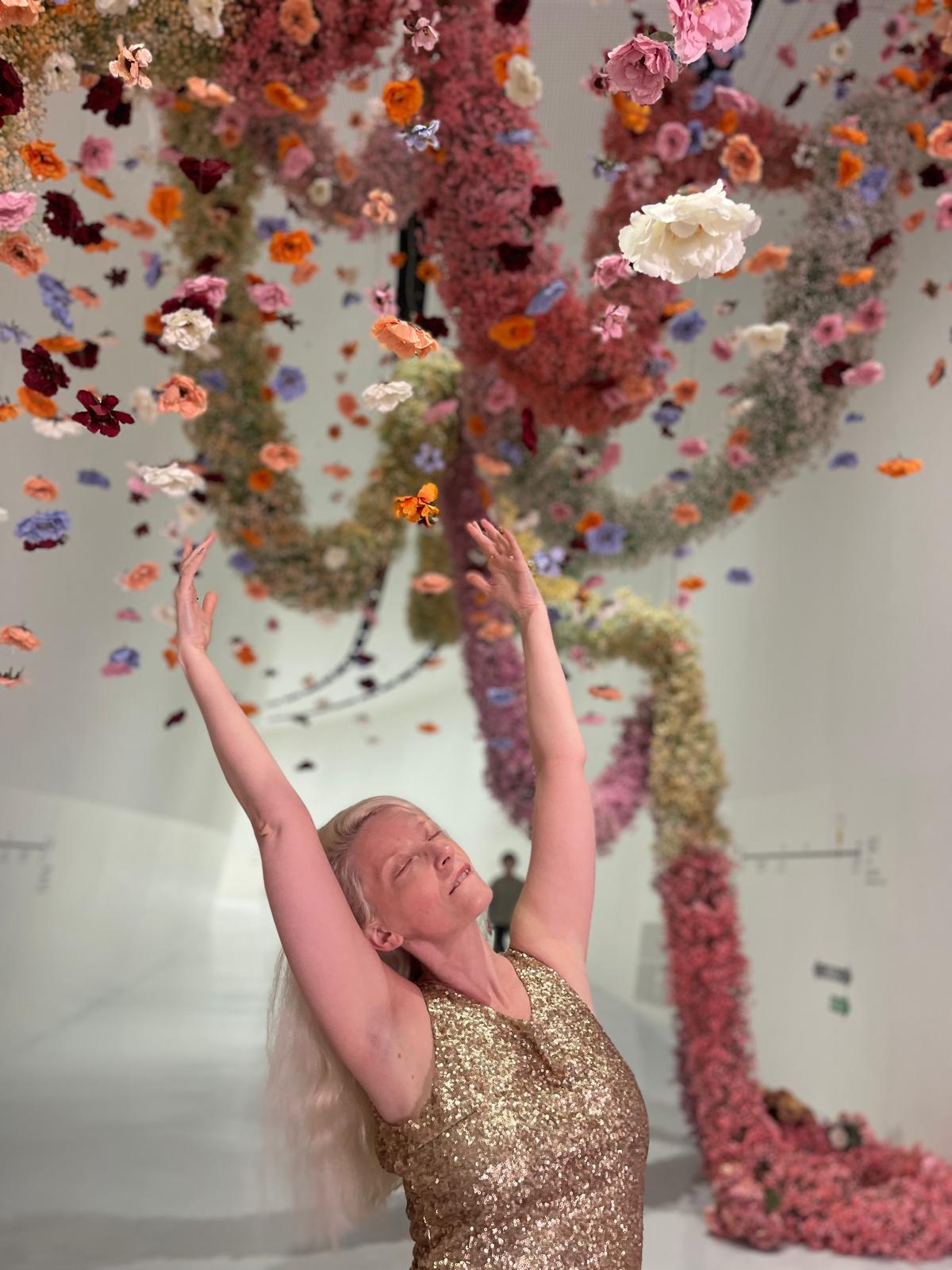 woman posing under flowers